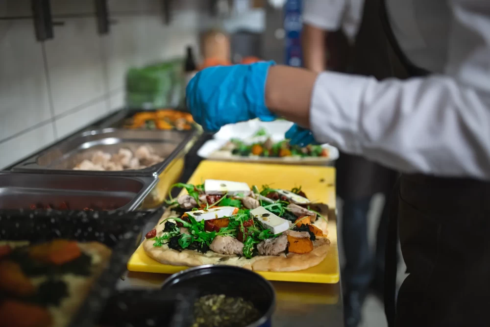 close-up-of-cook-preparing-meal-in-commercial-kitc-2022-01-28-02-53-38-utc.webp