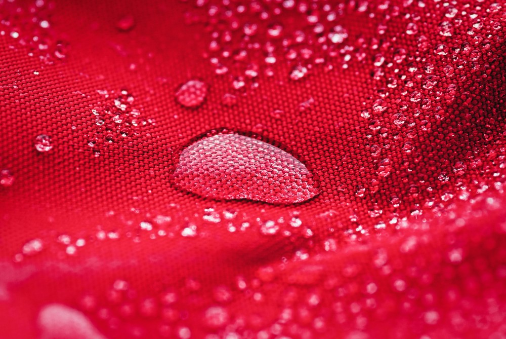 large-water-drop-on-red-waterproof-fabric-2023-11-27-05-17-19-utc.jpg