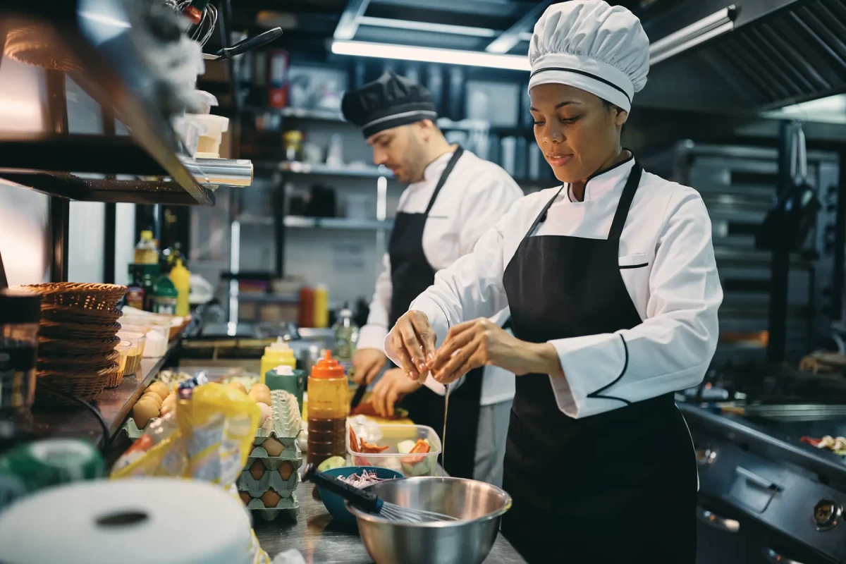 black-female-chef-cracking-an-egg-while-preparing-2022-11-29-22-43-46-utc.webp