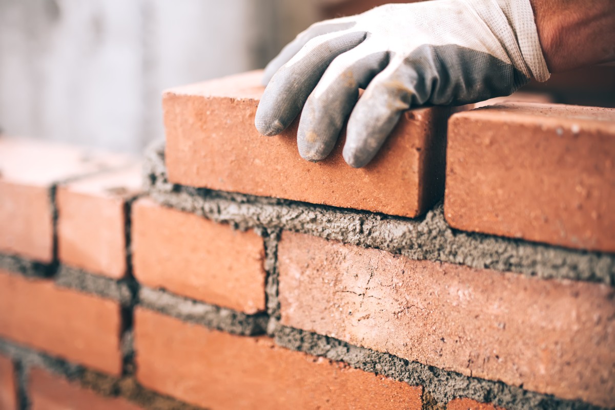 close-up-of-industrial-bricklayer-installing-brick-2023-11-27-05-29-26-utc.jpg