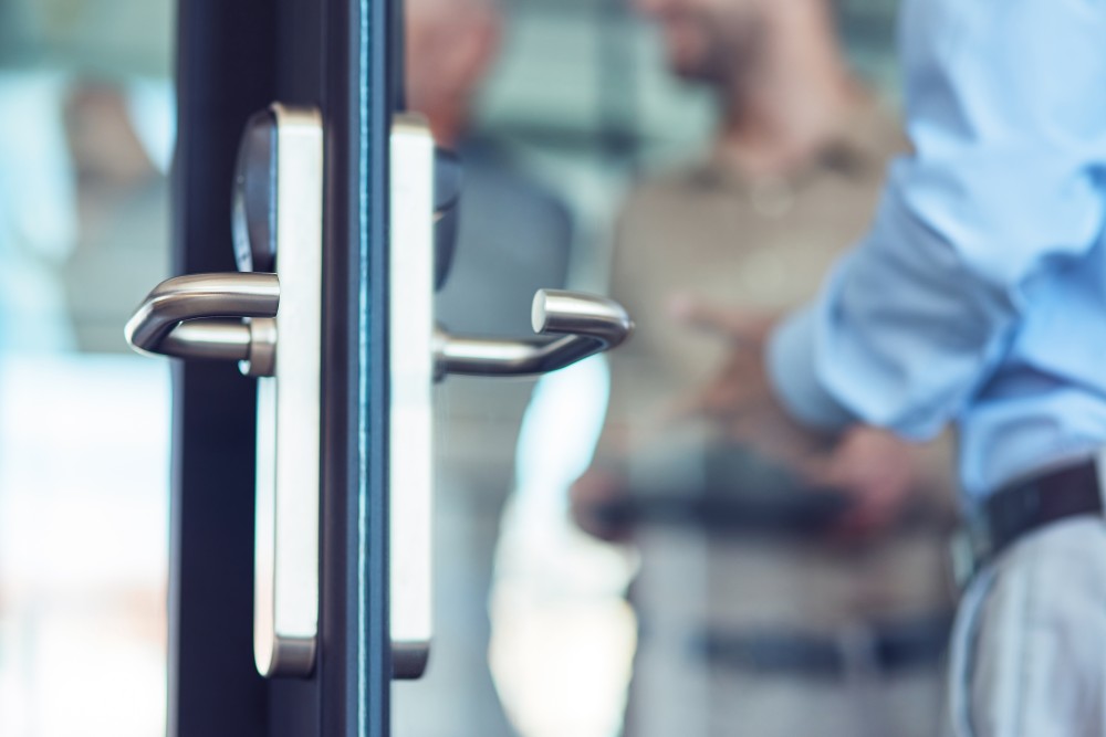 businessman-entering-at-work-opening-glass-door-i-2023-11-27-05-28-13-utc.jpg