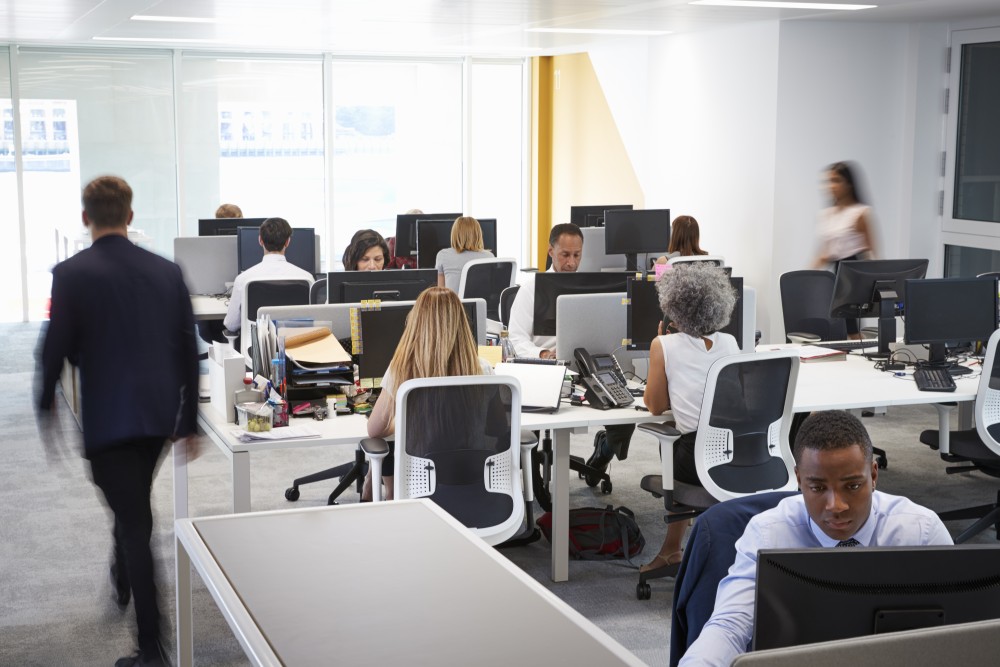 man-walking-through-a-busy-open-plan-office-2023-11-27-05-06-53-utc.jpg