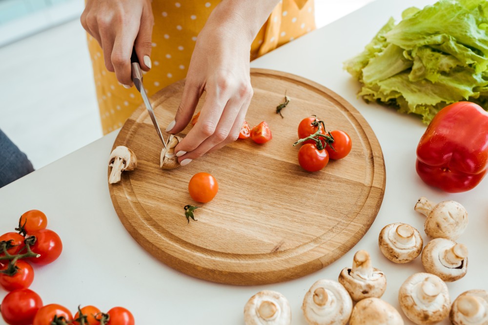 cropped-view-of-woman-in-polka-dot-apron-cutting-m-2023-11-27-05-31-18-utc.jpg