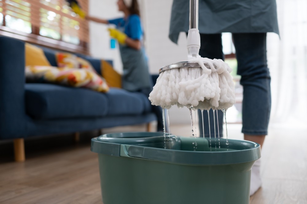 close-up-of-mop-and-bucket-with-cleaning-products-2023-11-27-05-06-40-utc.jpg